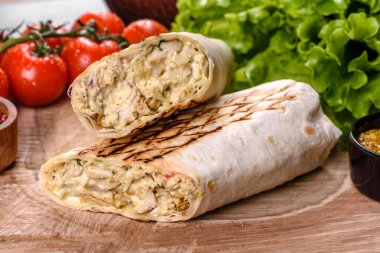 Koyu beton bir masada et ve sebzeli leziz taze shawarma. Fast food, Türk mutfağı