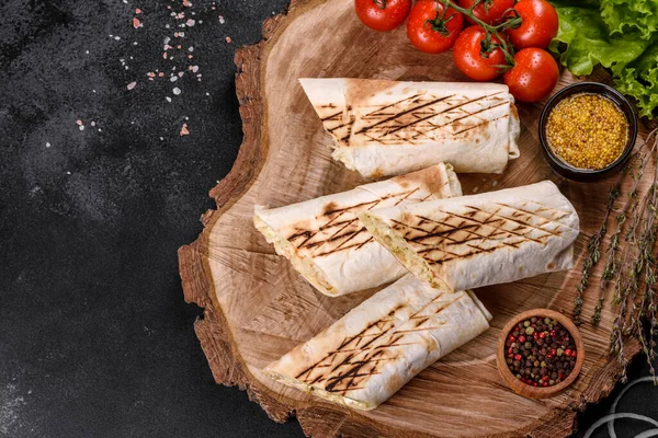 Koyu beton bir masada et ve sebzeli leziz taze shawarma. Fast food, Türk mutfağı