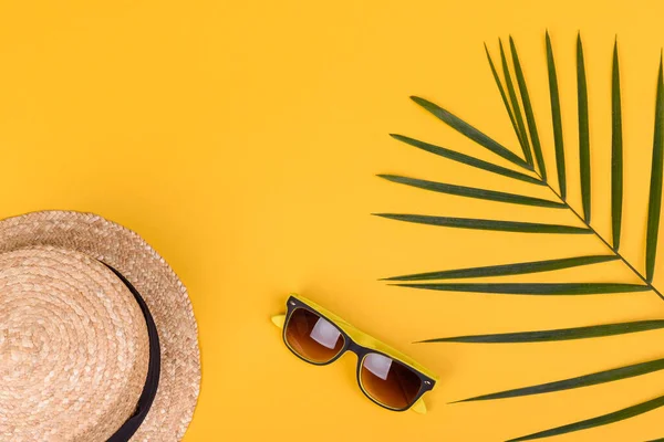 Plaj aksesuarları: kabuklu gözlük ve şapka ve renkli arka planda deniz yıldızları. Yaz arkaplanı