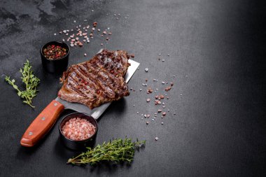 Lezzetli taze biftek, esrarlı baharatlar ve çimento kaplı otlar. Izgara yemek.