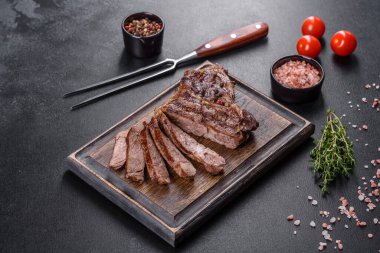 Lezzetli taze biftek, esrarlı baharatlar ve çimento kaplı otlar. Izgara yemek.