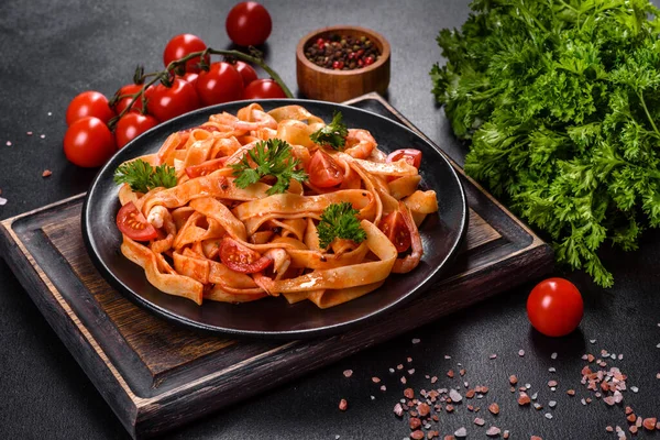 Fettuccine pasta with shrimp, cherry tomatoes, sauce, spices and herbs. Mediterranean cuisine
