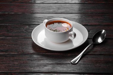 Dish of russian hodgepodge soup and other food on a wooden table. clipart