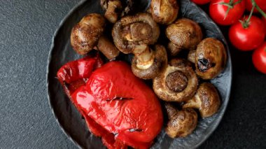 Grilled mushroom pieces, a vegetarian healthy meal with sauce. Barbecue mushroom halves