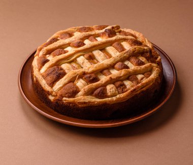 Sweet American pie with apples, pears, and cinnamon, a homemade dessert. Apple American pie as a food background for your design.