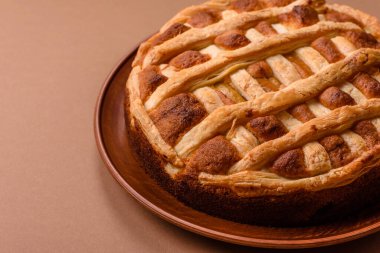 Sweet American pie with apples, pears, and cinnamon, a homemade dessert. Apple American pie as a food background for your design.