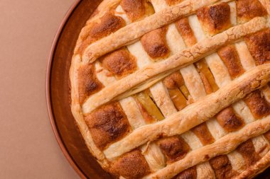 Sweet American pie with apples, pears, and cinnamon, a homemade dessert. Apple American pie as a food background for your design.