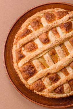 Sweet American pie with apples, pears, and cinnamon, a homemade dessert. Apple American pie as a food background for your design.