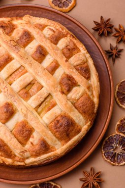 Sweet American pie with apples, pears, and cinnamon, a homemade dessert. Apple American pie as a food background for your design.