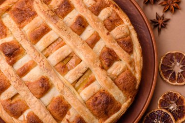 Sweet American pie with apples, pears, and cinnamon, a homemade dessert. Apple American pie as a food background for your design.