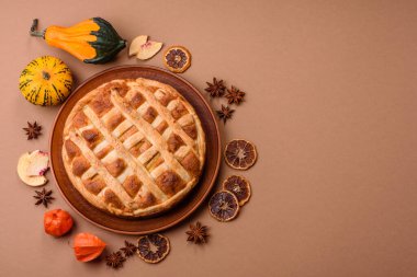 Sweet American pie with apples, pears, and cinnamon, a homemade dessert. Apple American pie as a food background for your design.