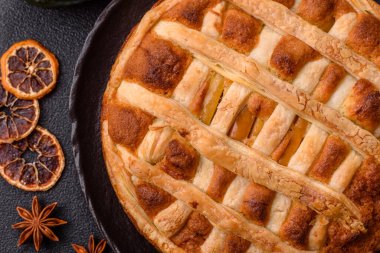 Sweet American pie with apples, pears, and cinnamon, a homemade dessert. Apple American pie as a food background for your design.