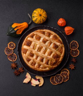 Sweet American pie with apples, pears, and cinnamon, a homemade dessert. Apple American pie as a food background for your design.