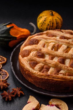 Sweet American pie with apples, pears, and cinnamon, a homemade dessert. Apple American pie as a food background for your design.