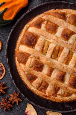 Sweet American pie with apples, pears, and cinnamon, a homemade dessert. Apple American pie as a food background for your design.