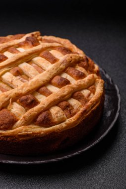 Sweet American pie with apples, pears, and cinnamon, a homemade dessert. Apple American pie as a food background for your design.