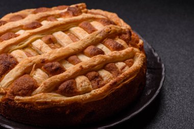 Sweet American pie with apples, pears, and cinnamon, a homemade dessert. Apple American pie as a food background for your design.