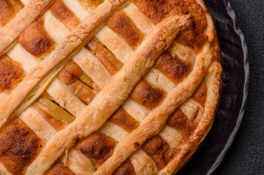 Sweet American pie with apples, pears, and cinnamon, a homemade dessert. Apple American pie as a food background for your design.