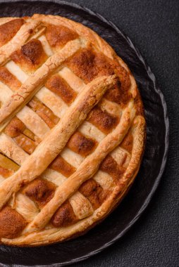 Sweet American pie with apples, pears, and cinnamon, a homemade dessert. Apple American pie as a food background for your design.
