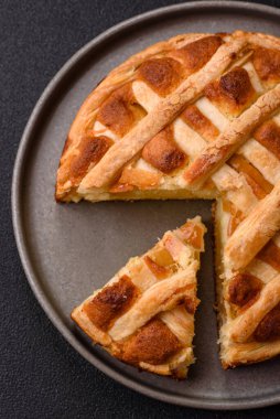 Sweet American pie with apples, pears, and cinnamon, a homemade dessert. Apple American pie as a food background for your design.