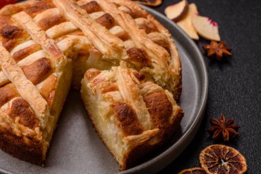 Sweet American pie with apples, pears, and cinnamon, a homemade dessert. Apple American pie as a food background for your design.