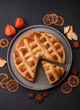 Sweet American pie with apples, pears, and cinnamon, a homemade dessert. Apple American pie as a food background for your design.