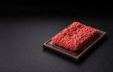 Raw ground beef for a burger or as an ingredient in a meat dish. Raw ground beef as a food background for your design