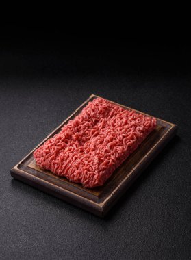 Raw ground beef for a burger or as an ingredient in a meat dish. Raw ground beef as a food background for your design