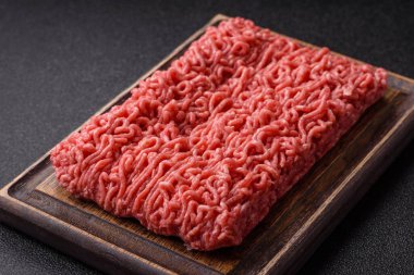 Raw ground beef for a burger or as an ingredient in a meat dish. Raw ground beef as a food background for your design