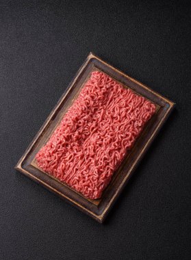 Raw ground beef for a burger or as an ingredient in a meat dish. Raw ground beef as a food background for your design