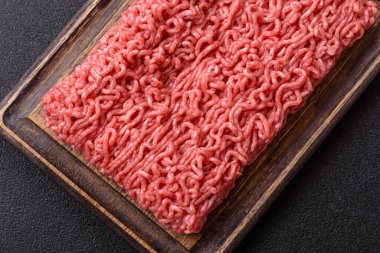 Raw ground beef for a burger or as an ingredient in a meat dish. Raw ground beef as a food background for your design
