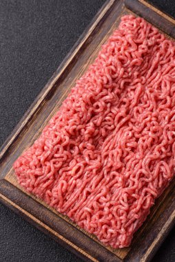 Raw ground beef for a burger or as an ingredient in a meat dish. Raw ground beef as a food background for your design