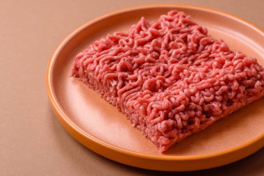 Raw ground beef for a burger or as an ingredient in a meat dish. Raw ground beef as a food background for your design