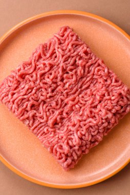 Raw ground beef for a burger or as an ingredient in a meat dish. Raw ground beef as a food background for your design