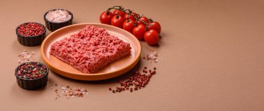 Raw ground beef for a burger or as an ingredient in a meat dish. Raw ground beef as a food background for your design