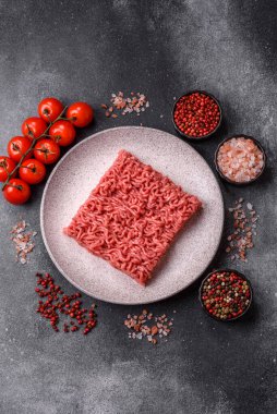 Raw ground beef for a burger or as an ingredient in a meat dish. Raw ground beef as a food background for your design