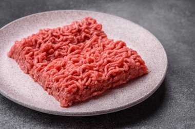 Raw ground beef for a burger or as an ingredient in a meat dish. Raw ground beef as a food background for your design