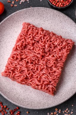 Raw ground beef for a burger or as an ingredient in a meat dish. Raw ground beef as a food background for your design