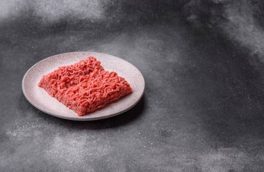 Raw ground beef for a burger or as an ingredient in a meat dish. Raw ground beef as a food background for your design