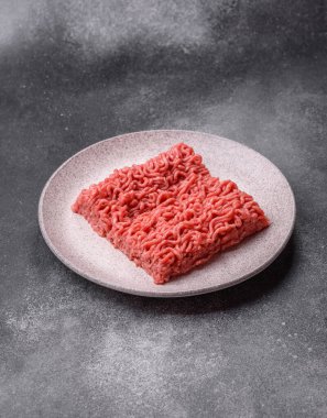 Raw ground beef for a burger or as an ingredient in a meat dish. Raw ground beef as a food background for your design