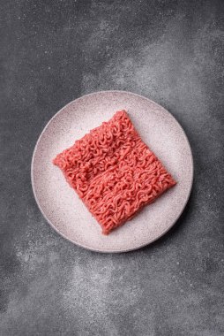 Raw ground beef for a burger or as an ingredient in a meat dish. Raw ground beef as a food background for your design