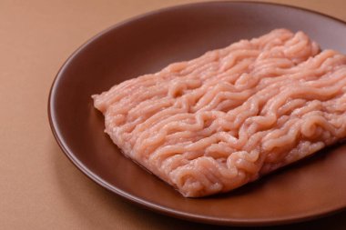 Raw minced chicken for a burger or as an ingredient in a meat dish. Raw ground chicken as a food background for your design