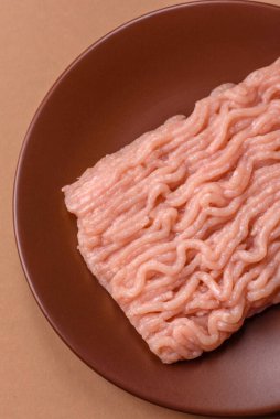 Raw minced chicken for a burger or as an ingredient in a meat dish. Raw ground chicken as a food background for your design
