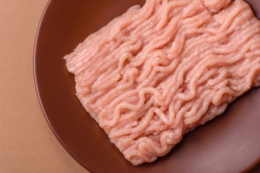 Raw minced chicken for a burger or as an ingredient in a meat dish. Raw ground chicken as a food background for your design