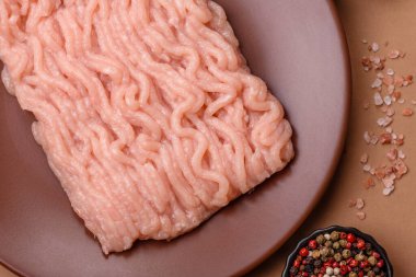 Raw minced chicken for a burger or as an ingredient in a meat dish. Raw ground chicken as a food background for your design