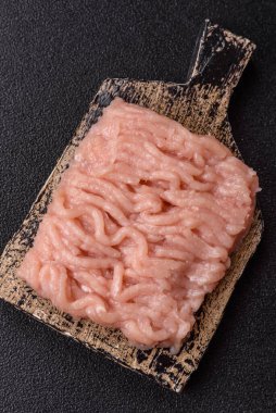 Raw minced chicken for a burger or as an ingredient in a meat dish. Raw ground chicken as a food background for your design