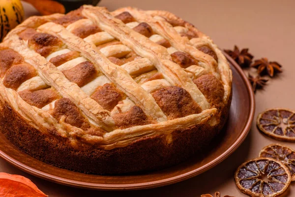 Sweet American pie with apples, pears, and cinnamon, a homemade dessert. Apple American pie as a food background for your design.