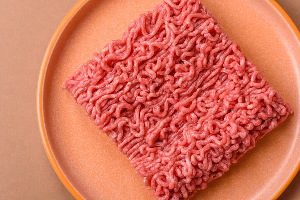 Raw ground beef for a burger or as an ingredient in a meat dish. Raw ground beef as a food background for your design