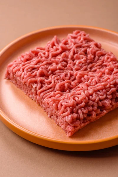 Raw ground beef for a burger or as an ingredient in a meat dish. Raw ground beef as a food background for your design