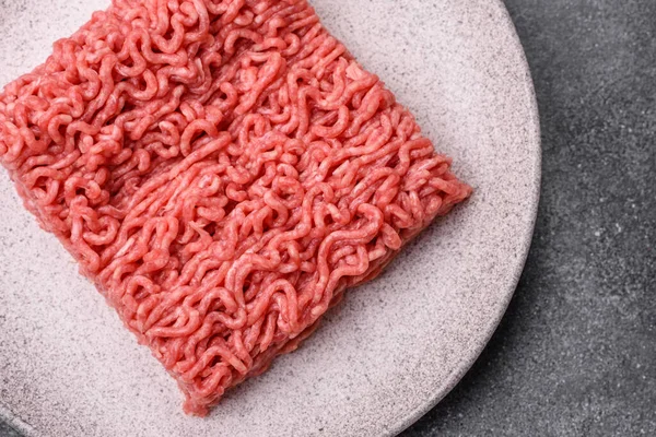 Raw ground beef for a burger or as an ingredient in a meat dish. Raw ground beef as a food background for your design